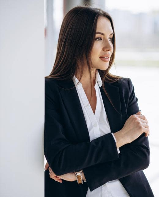 Business woman standing in office in formal wear